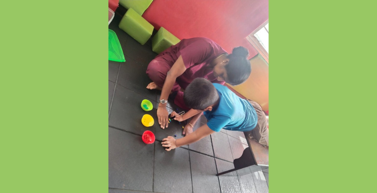 Occupational therapist practicing co-regulation strategies with a child with ADHD during therapy.