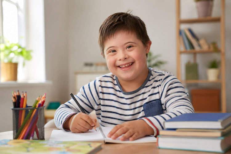 Child with Down syndrome participating in personalized therapy to improve communication, motor skills, social interaction, confidence, and independent daily living.