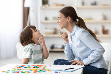 A therapist modeling natural language and connection with a child in a play session.